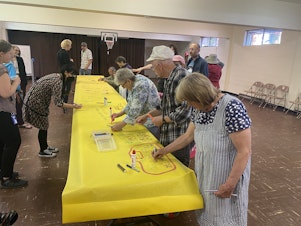 caption: On May 10, 2023, people gathered at Lamb of God Church to share memories and grieve the loss of the Lake City Community Center nearby, which closed after a fire April 18. 