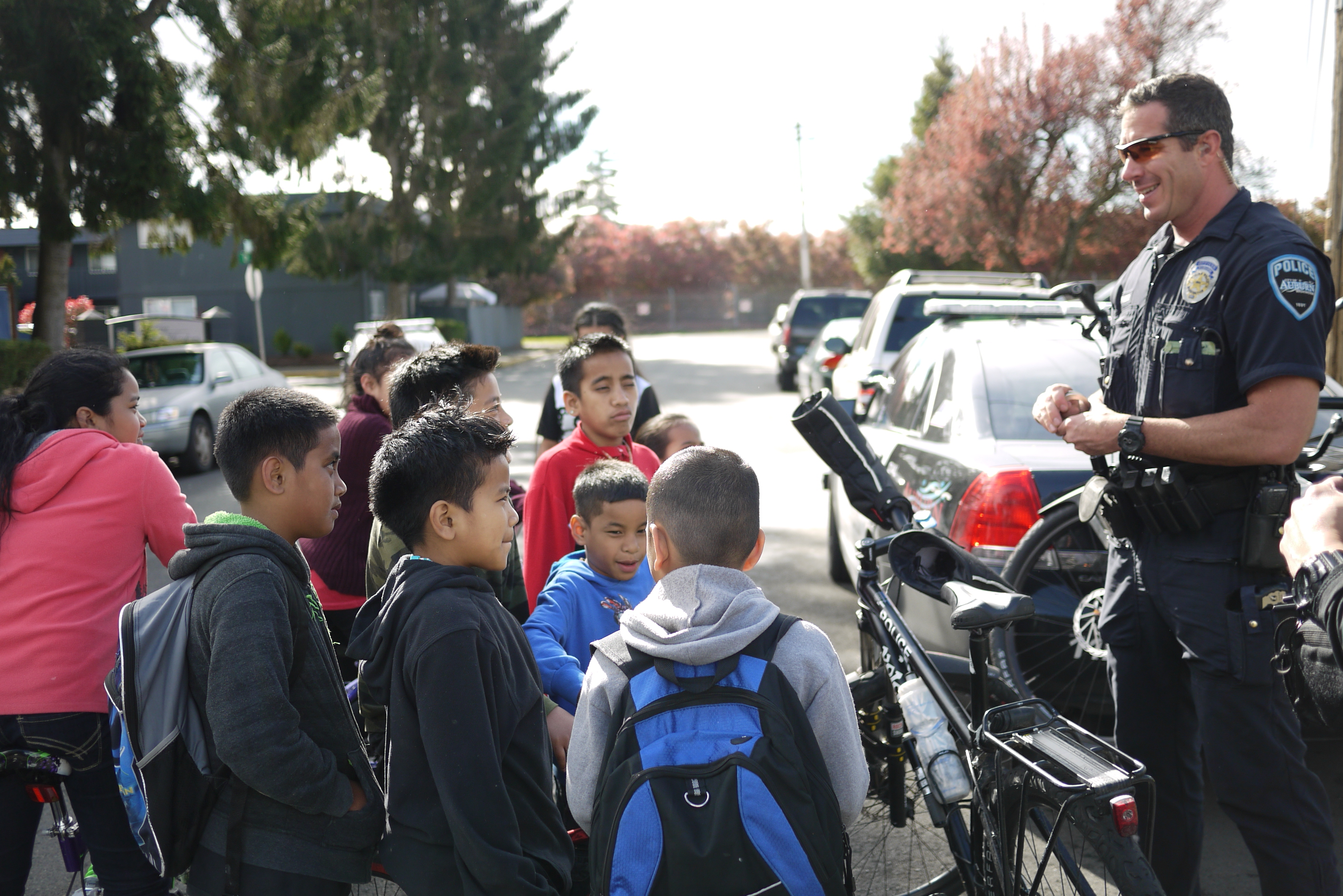 caption: Auburn Police Officer Chris Pakney gets candid questions from some local kids.