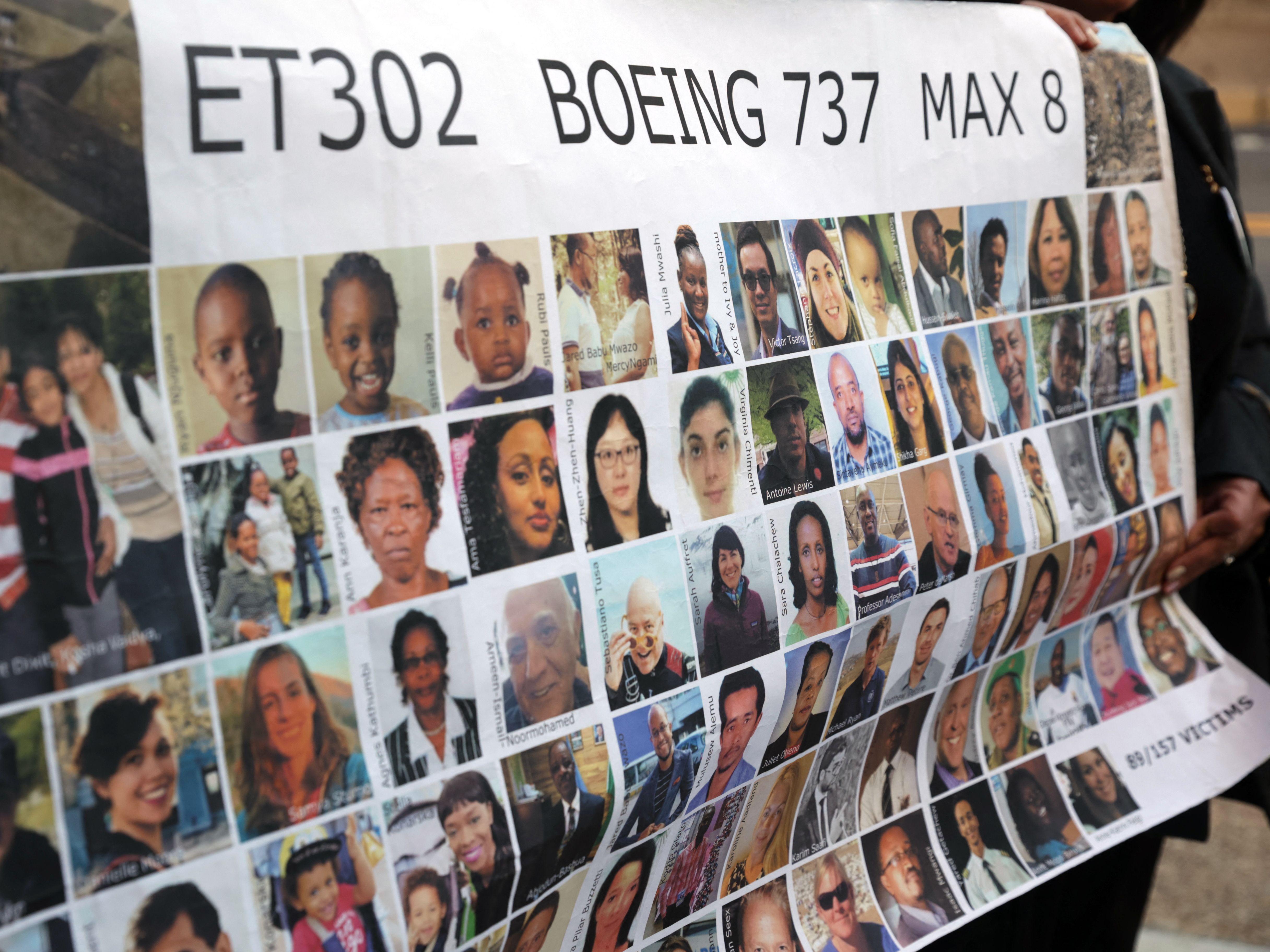 caption: Relatives of victims hold a placard with photos of victims of the Ethiopian Airlines Flight 302 crash in March 2019, prior to a hearing in Fort Worth, Texas, in January 2023.