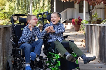 caption: Brothers Chase Miller (left), 10, and Carson Miller, 11, in November 2021. The two brothers have a rare genetic disorder and are immunocompromised. Their family has to practice extreme caution to prevent coronavirus exposures.
