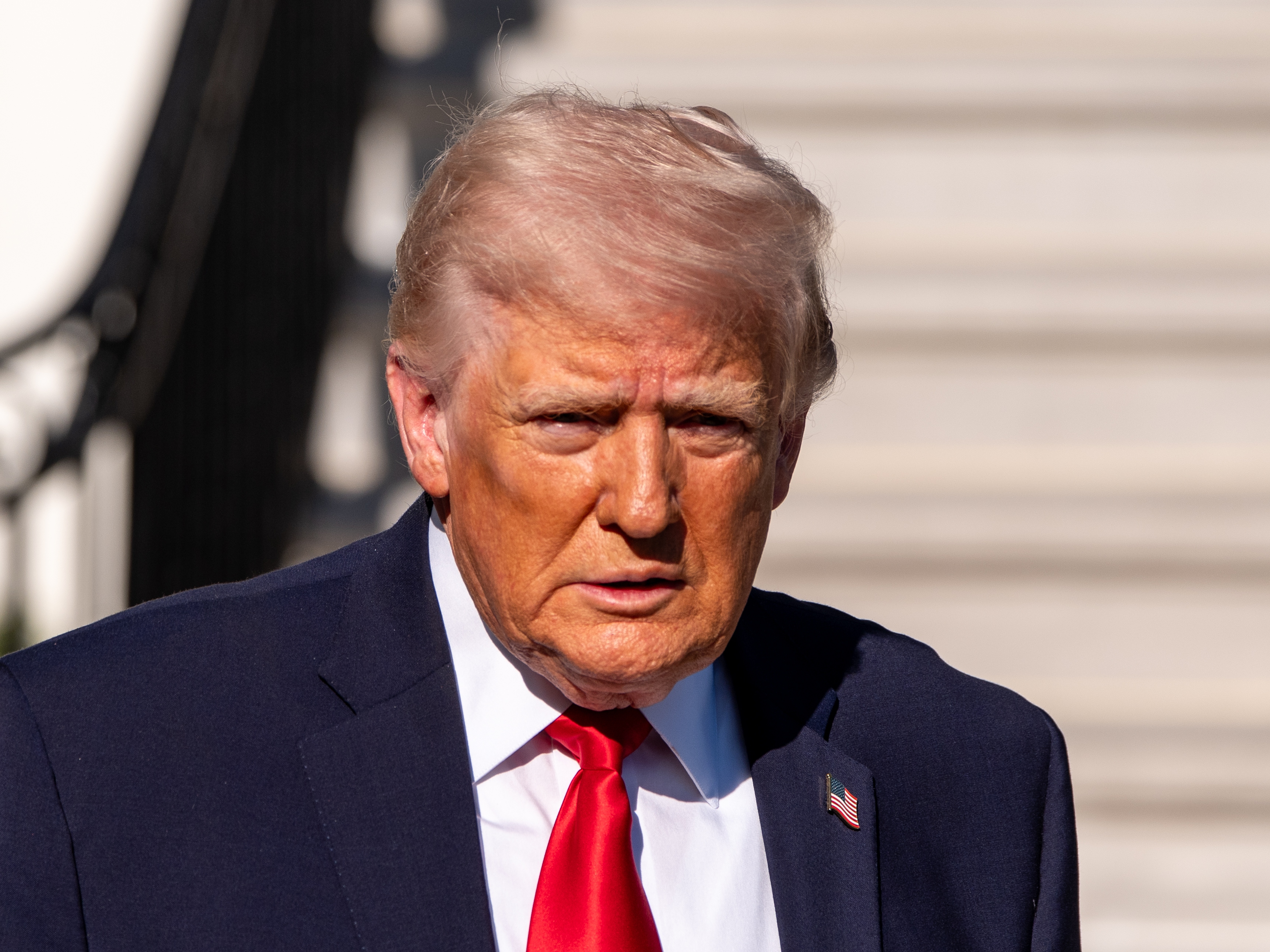 caption: President Trump speaks with reporters before departing on Marine One from the South Lawn of the White House on April 11 in Washington.