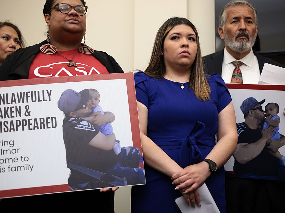 caption: The wife of Kilmar Abrego Garcia, Jennifer Vasquez Sura (center), listens during a news conference to discuss his husband's arrest and deportation on Capitol Hill on April 9.