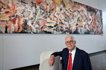 caption: Seattle real estate developer Richard Hedreen poses next to "Bring Me the Sunset in a Teacup" by painter Cecily
Brown, part of the $300 million collection Hedreen donated to Seattle University.
