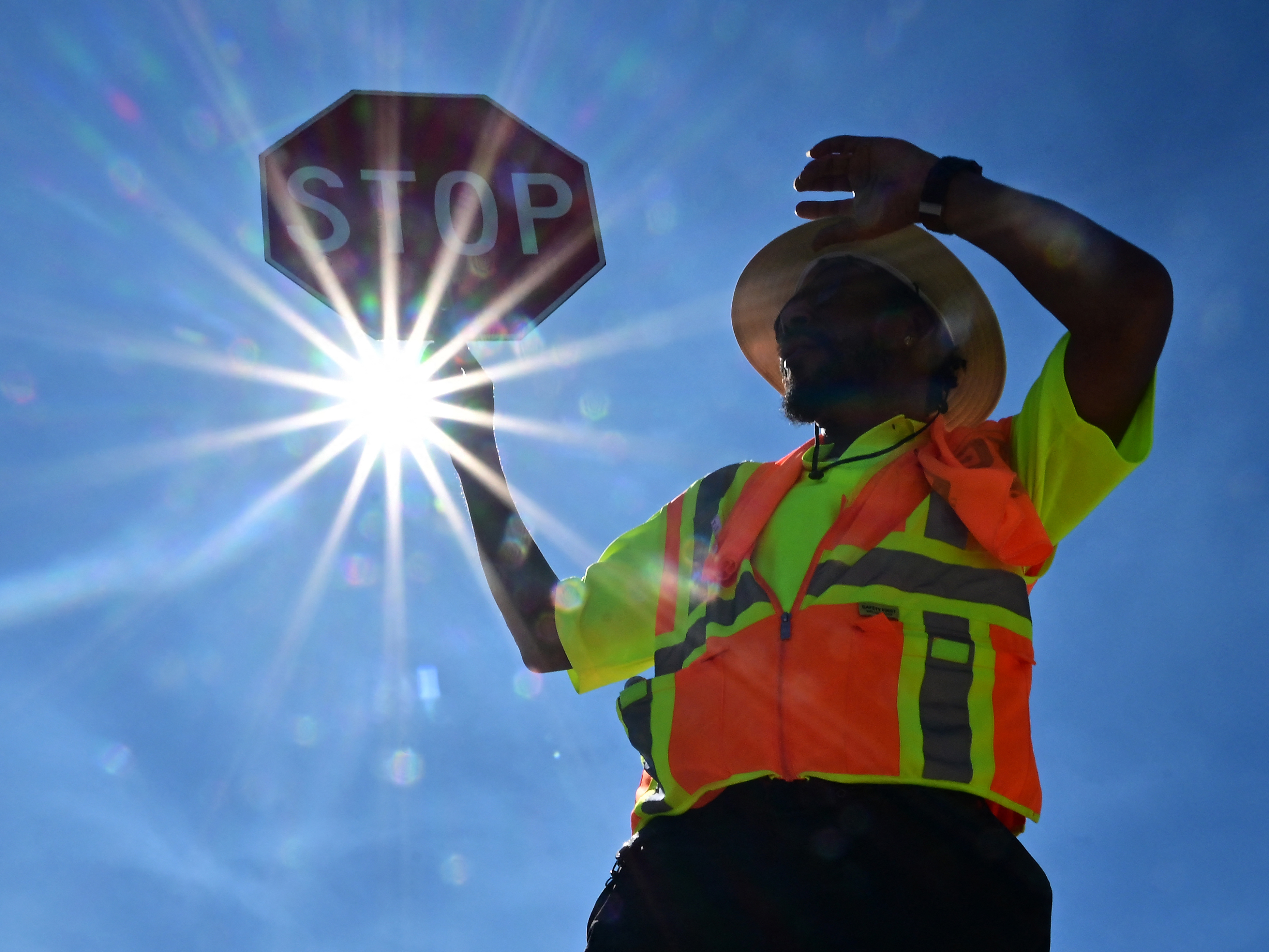 caption: Traffic warden Rai Rogers mans his street corner during temperatures as high as 106 in Las Vegas, Nevada on Wednesday.