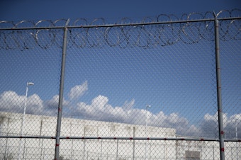 caption: A fence outside of the Northwest Detention Center, recently renamed the Northwest ICE Processing Center, is shown on Tuesday, Sept. 10, 2019, in Tacoma. 