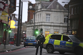 caption: London police say officers shot and killed a suspect in a "terrorist-related" stabbing incident Sunday.