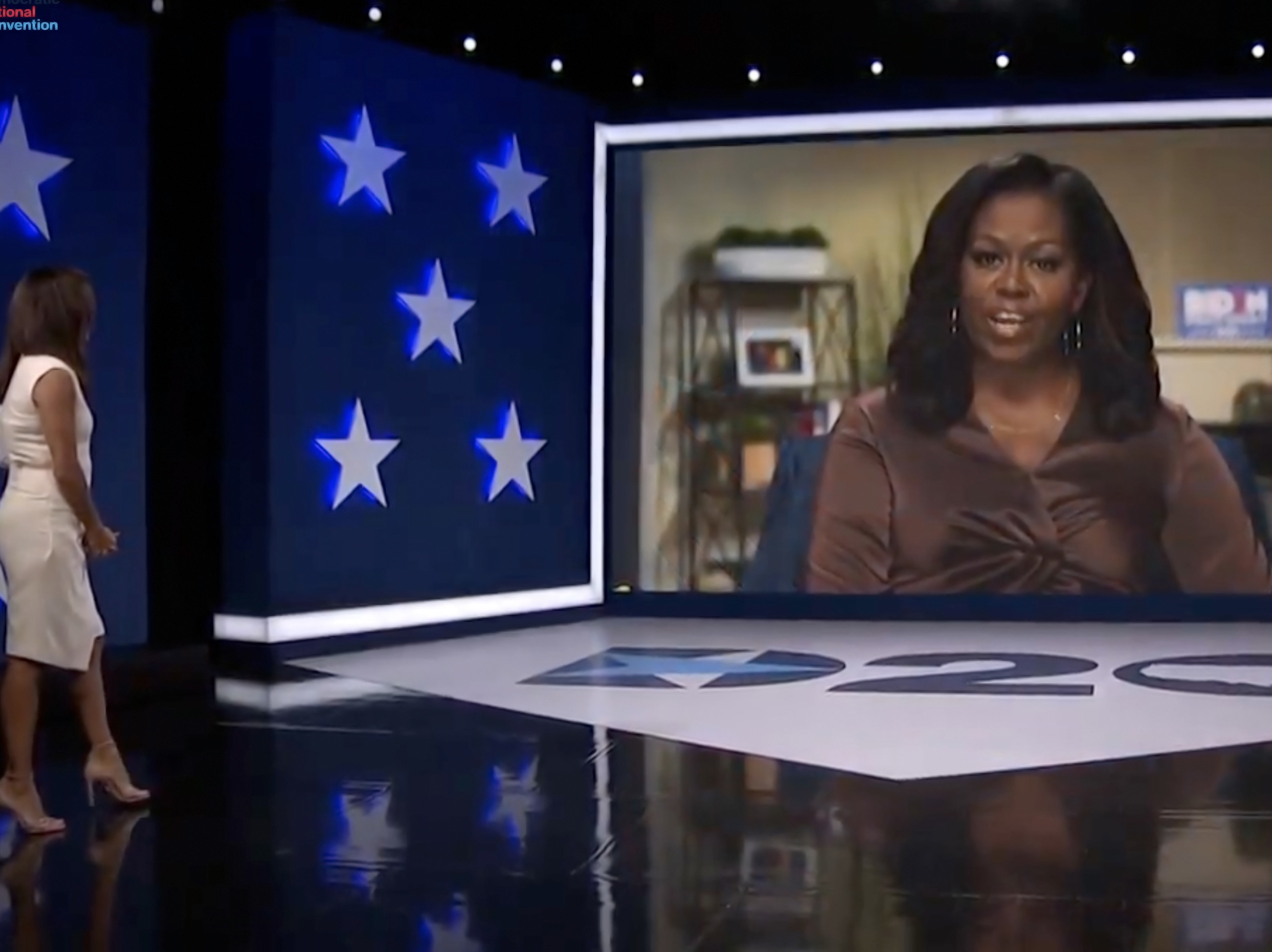 caption: In this screenshot from the 2020 Democratic National Convention's livestream, actress and activist Eva Longoria introduces former first lady Michelle Obama.
