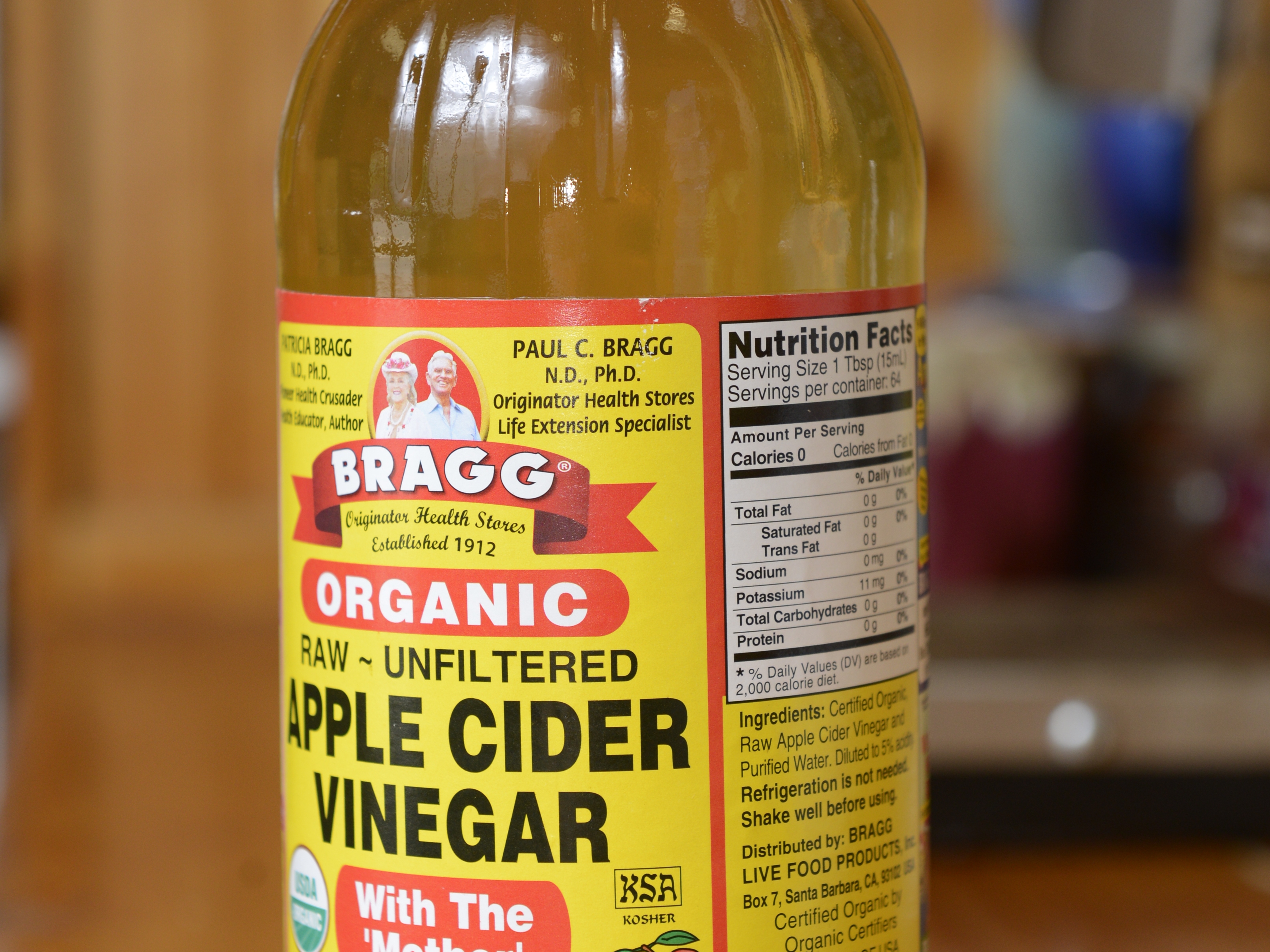 caption: A bottle of Bragg apple cider vinegar is shown in 2017.