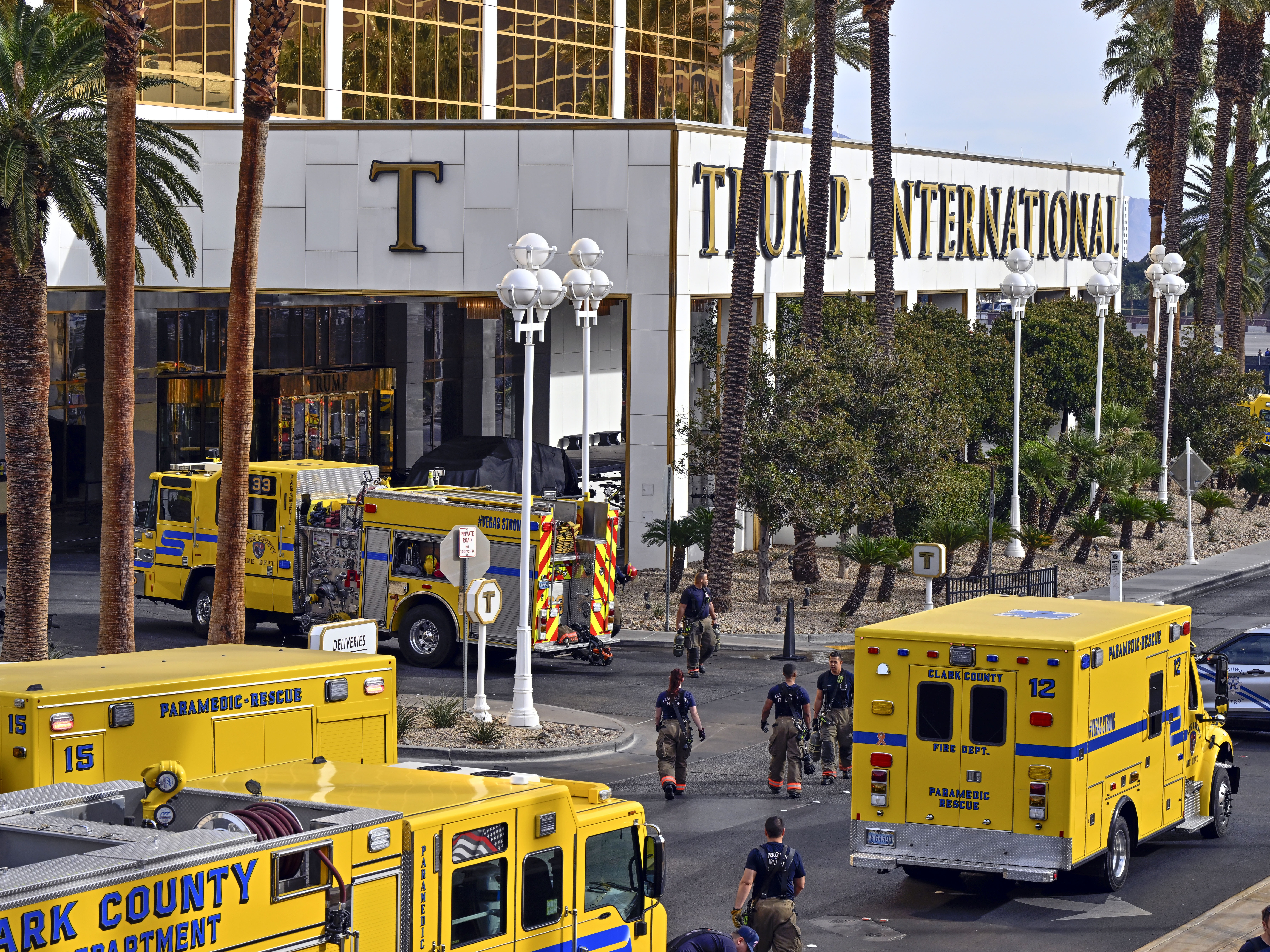 caption: Clark County fire vehicles surround the valet area where a Cybertruck caught fire at the Trump International Hotel on Jan. 1, in Las Vegas, Nevada.