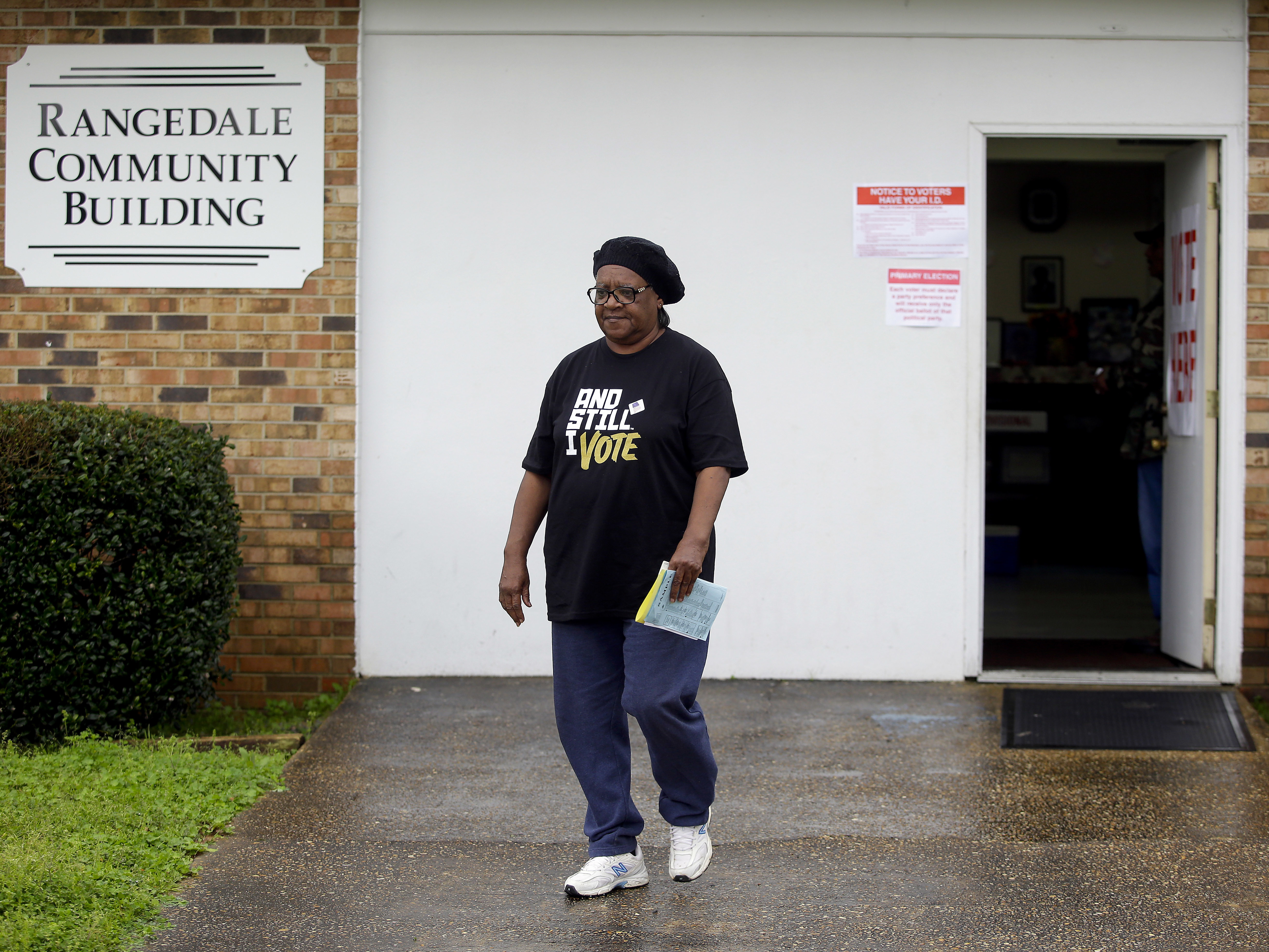 caption: A voter leaves the Rangedale Community Building during the presidential primary in Selma, Ala., on Super Tuesday.