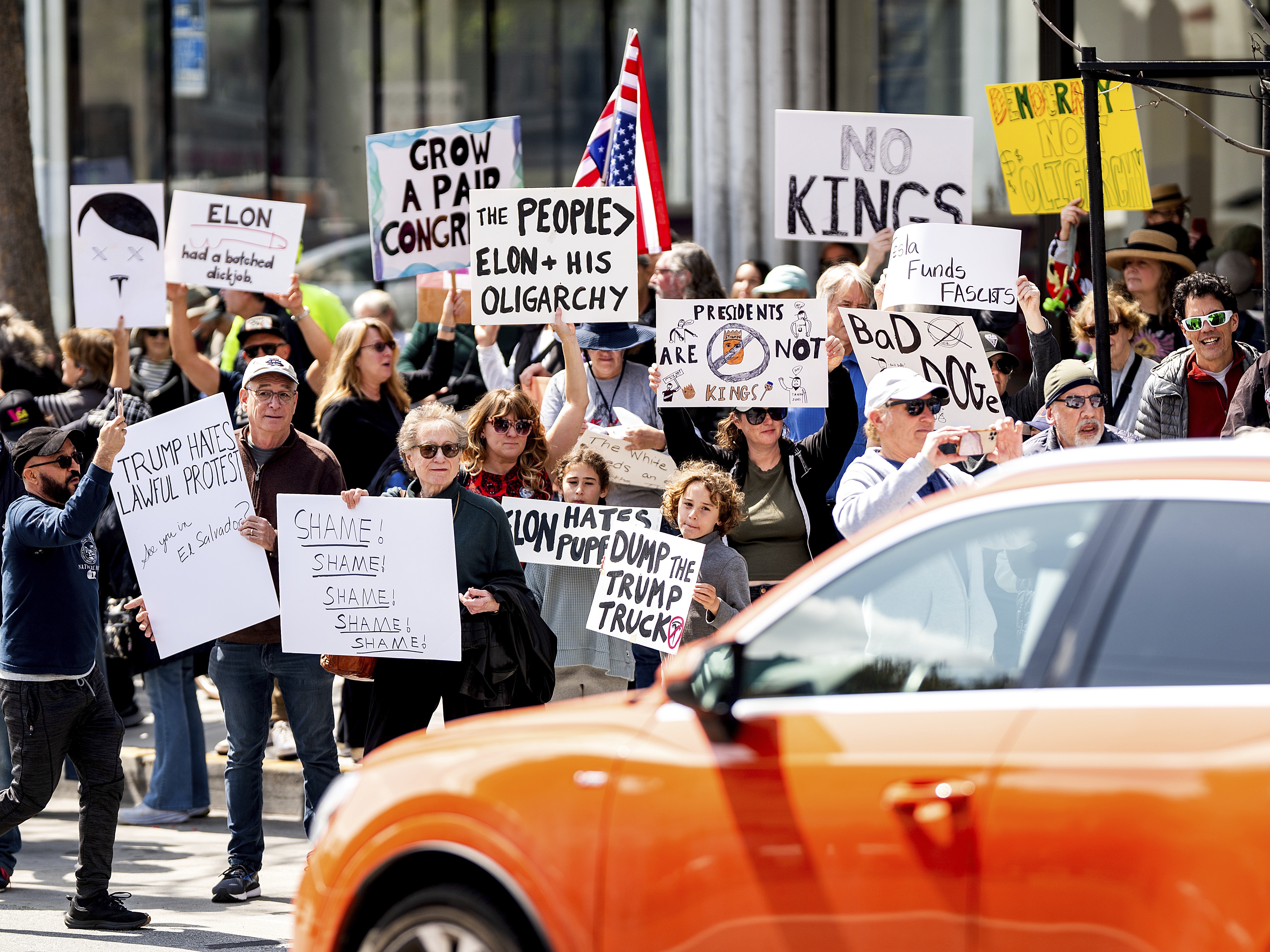 caption: Protesters rally against Tesla CEO Elon Musk outside a Tesla store in San Francisco on Saturday.