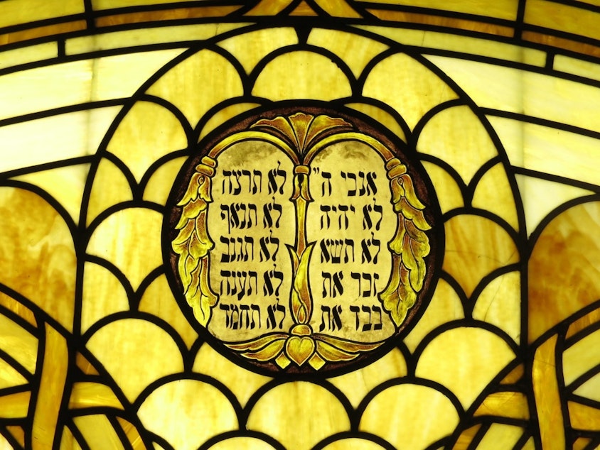 caption: A stained glass rendering of the Ten Commandments at Sephardic synagogue, Ezra Bessaroth in Seward Park. The synagogue was established by migrants from the island of Rhodes. 