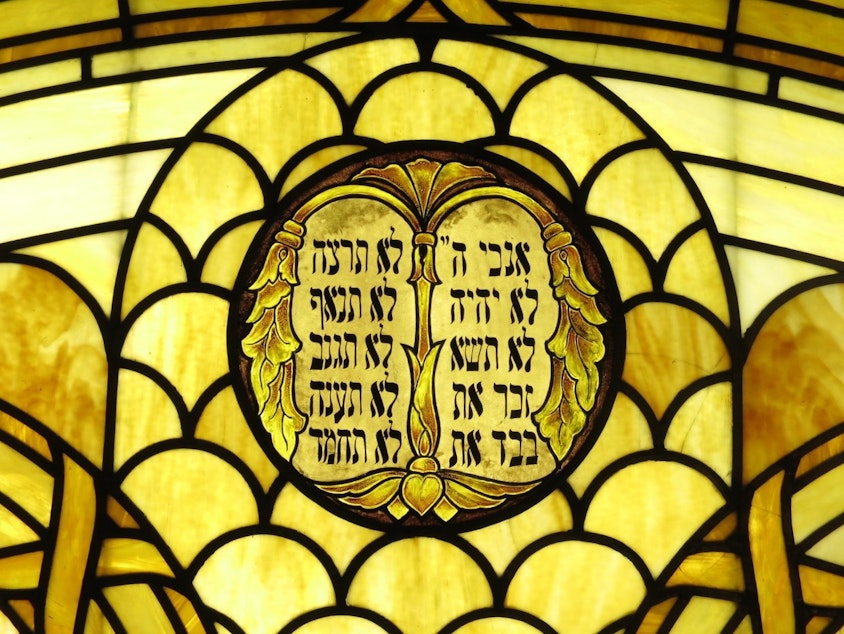caption: A stained glass rendering of the Ten Commandments at Sephardic synagogue, Ezra Bessaroth in Seward Park. The synagogue was established by migrants from the island of Rhodes.