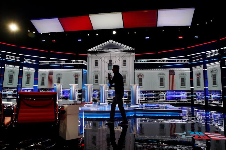 caption: A person walks across the stage during setup for the Nevada Democratic presidential debate Tuesday, Feb. 18, 2020, in Las Vegas. 