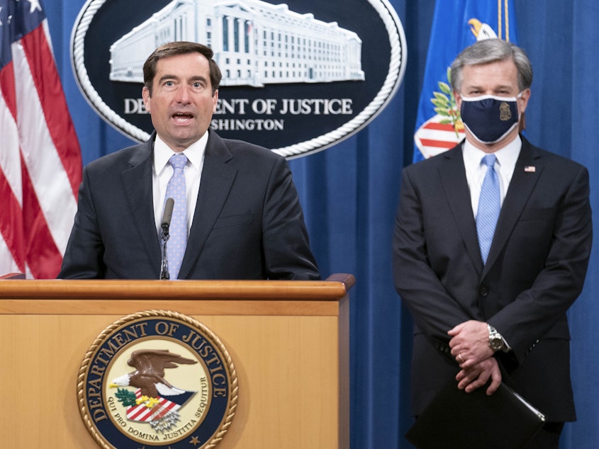 caption: Assistant Attorney General for National Security John Demers speaks during a virtual news conference at the Department of Justice, Wednesday, Oct. 28, 2020 with FBI Director Christopher Wray.
