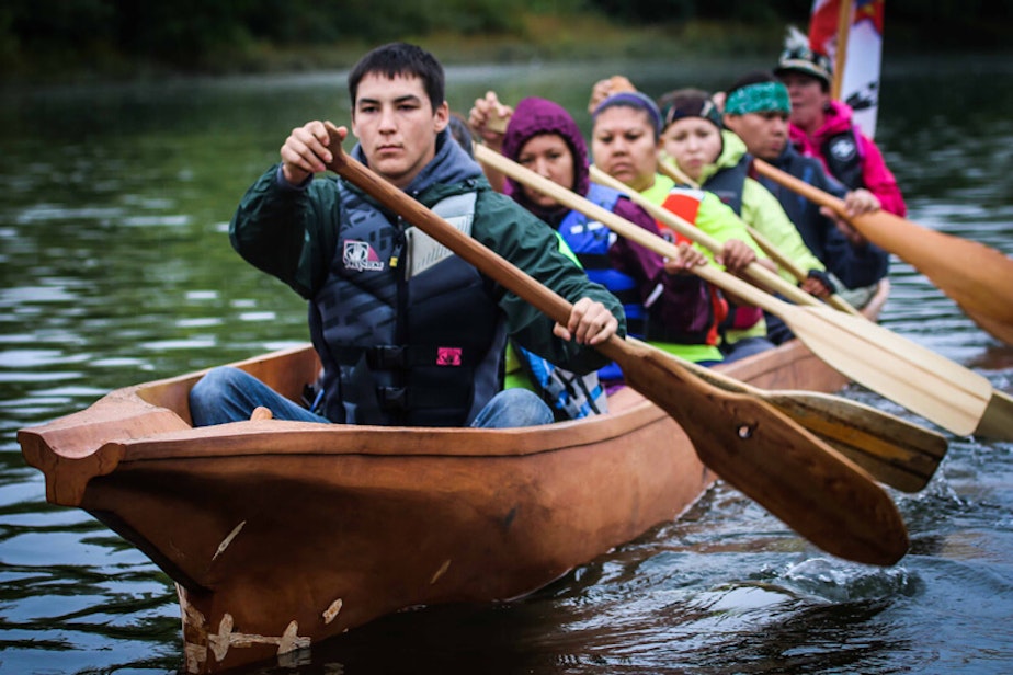 caption: Nez Perce tribal members paddle on the Snake River in a canoe they carved as part of a culture and environmental learning project supported by the Potlatch Fund.