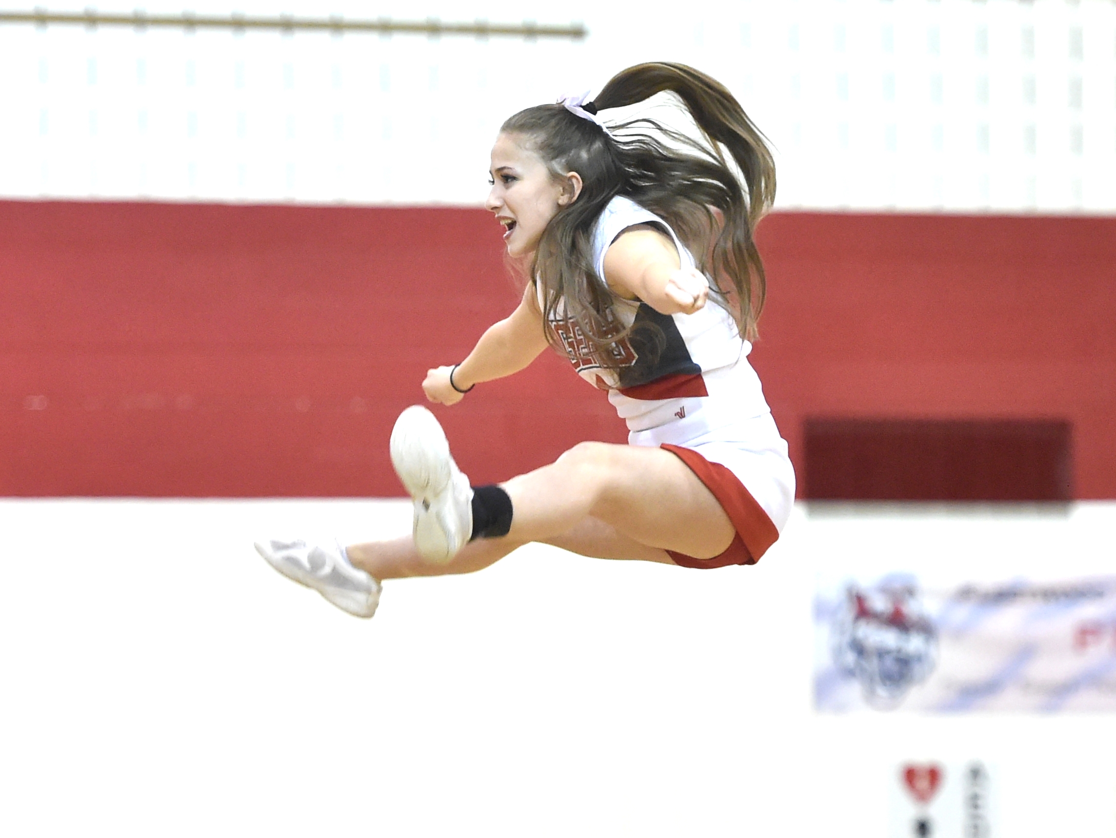 caption: Fleetwood High School cheerleader Samantha Colelli, 17, a senior at Fleetwood, does a basket during halftime at a game in 2017. As cheerleading has become more ambitious over the last decade, it's also become riskier warn pediatricians.