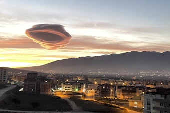 caption: Saucer-like lenticular clouds appear over Turkiye's Bursa province in the early morning hours of January 19, 2023.