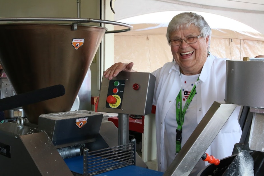 caption: Bach shows off the hopper, a machine that makes the scone making process more efficient.