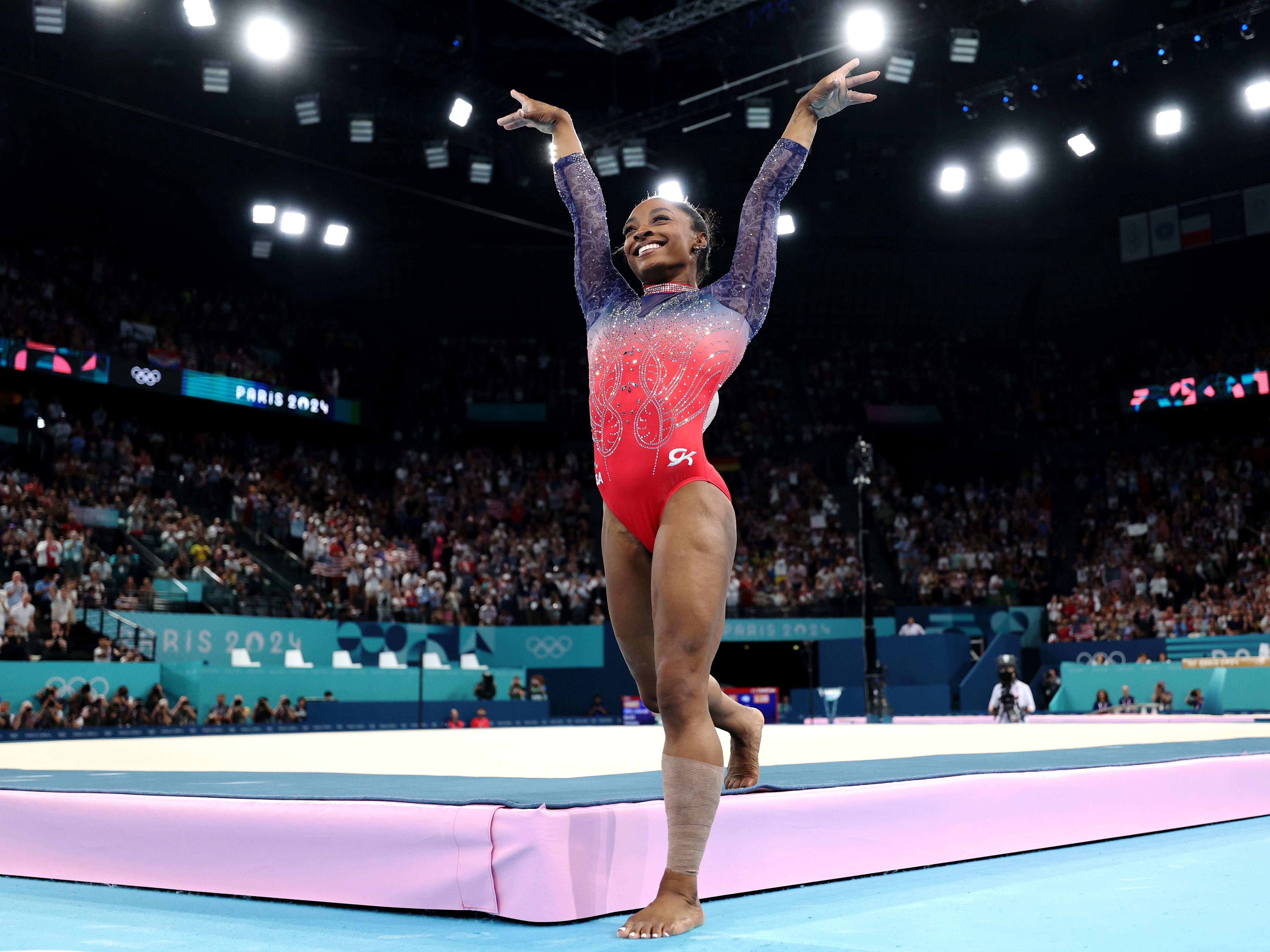 caption: The U.S.'s Simone Biles celebrates at the end of her floor exercise individual event final on Monday at the Paris Olympics. Biles finished in second to win a silver medal and her fourth overall medal of the Games. Her teammate, Jordan Chiles, took home the bronze.