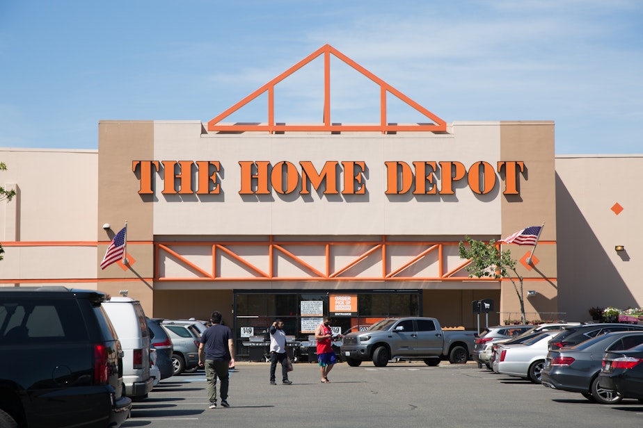 caption: Customers outside the Home Depot in Tukwila on Tuesday, July 14, 2020.