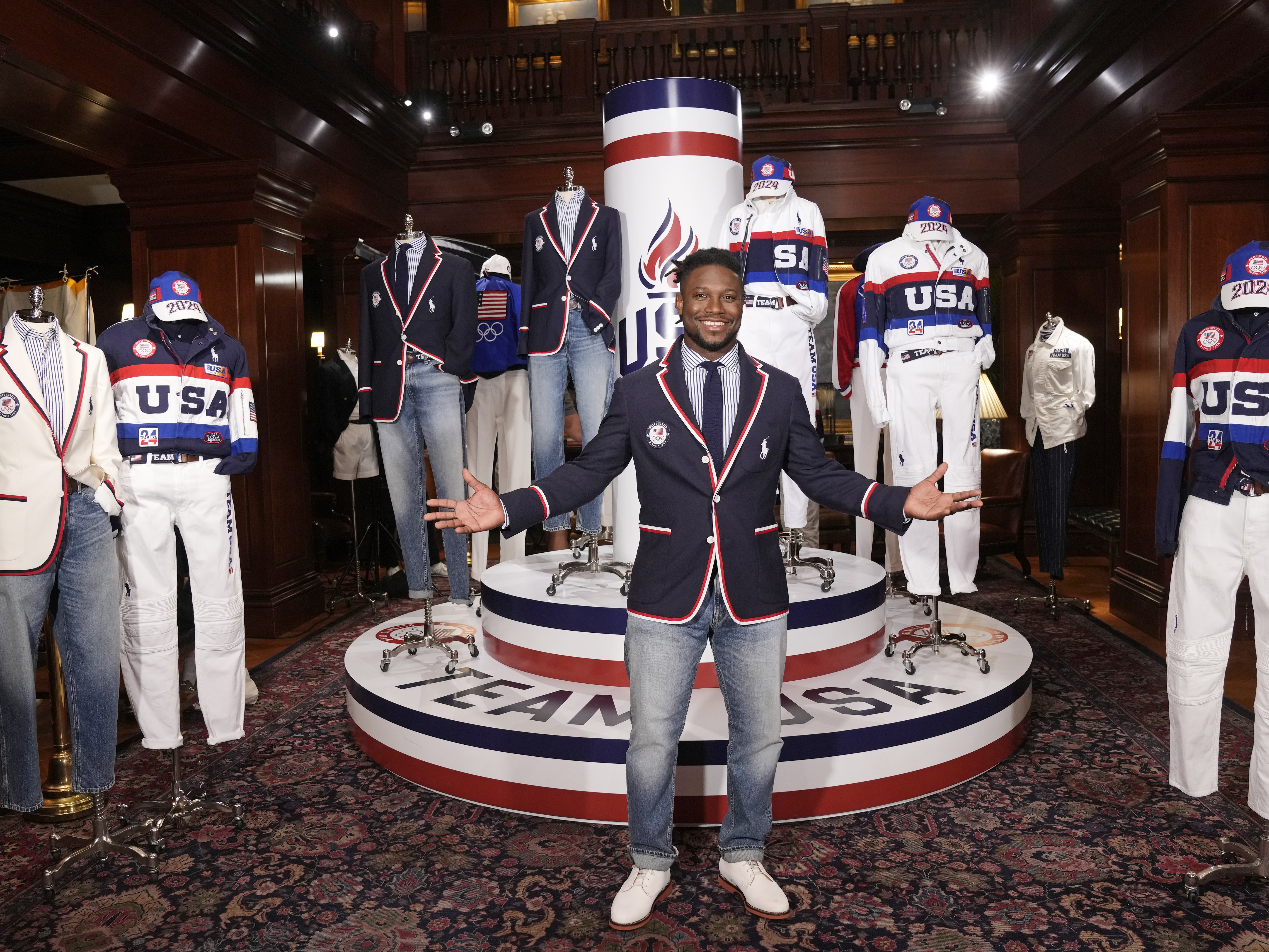 caption: Olympic athlete in fencing, Daryl Homer, models the Team USA Paris Olympics opening ceremony uniform at Ralph Lauren headquarters on Monday in New York.