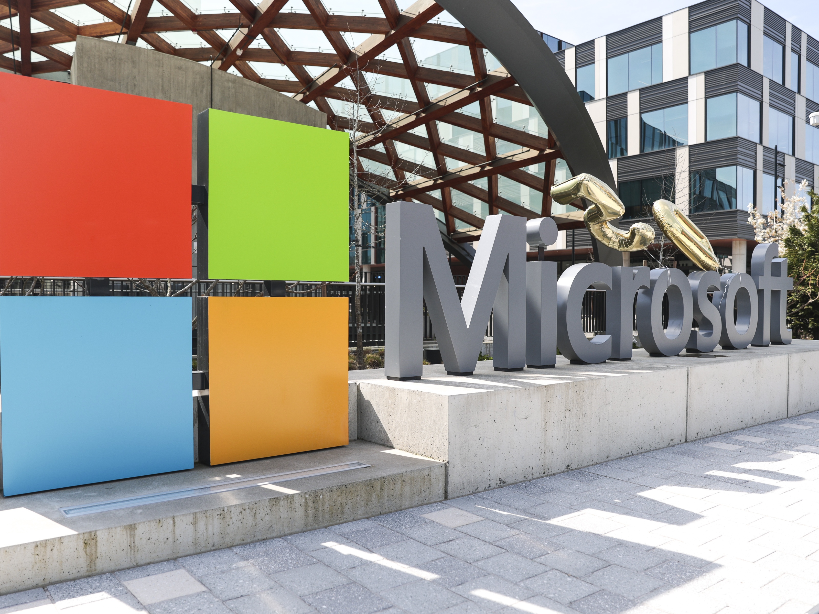 caption: A Microsoft sign and logo are pictured at the company's headquarters, Friday, April 4, 2025, in Redmond, Wash.