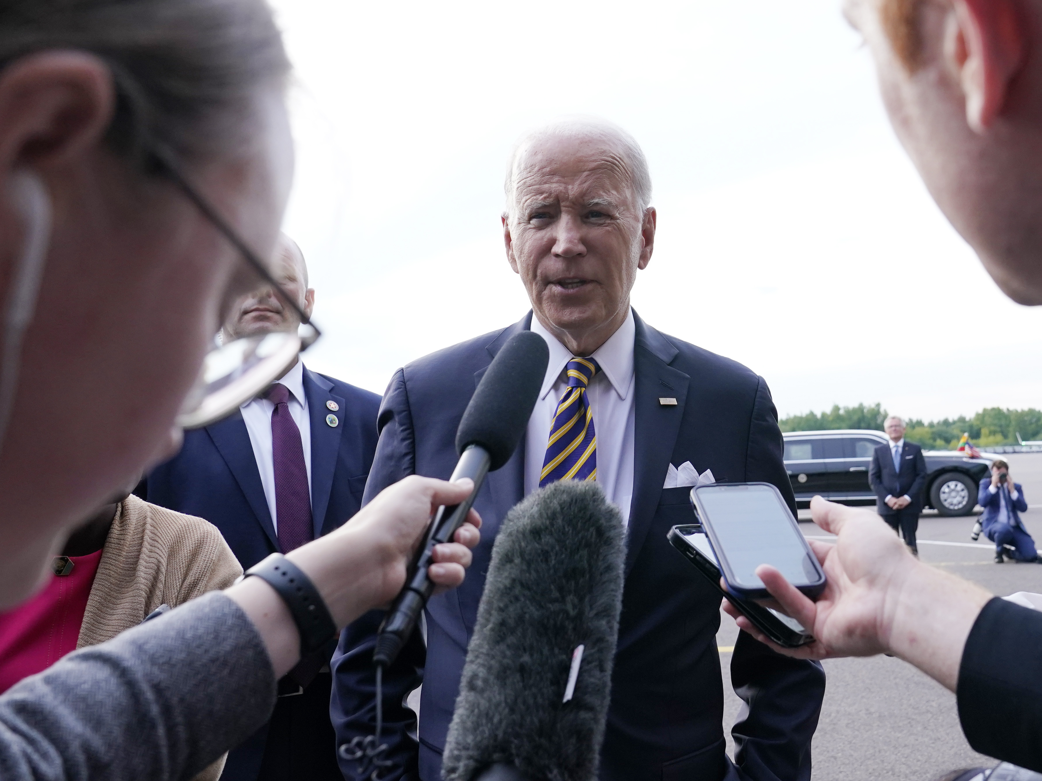 caption: President Biden speaks to reporters before boarding Air Force One in Vilnius, Lithuania. Biden was attending the NATO summit and was heading to Helsinki, Finland.