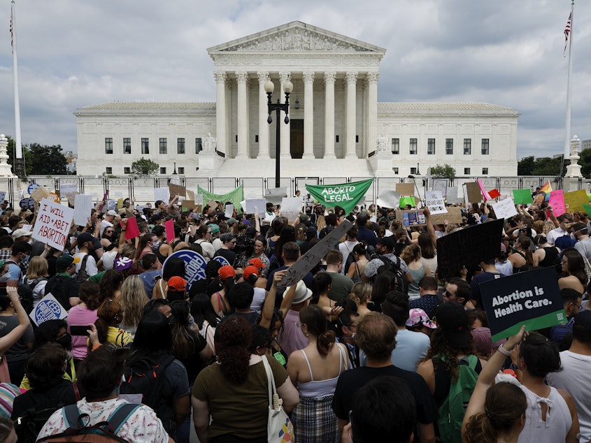 caption: Thousands of abortion-rights activists gather in front of the U.S. Supreme Court after it overturned the landmark <em>Roe v Wade</em> case and erased a federal right to an abortion.