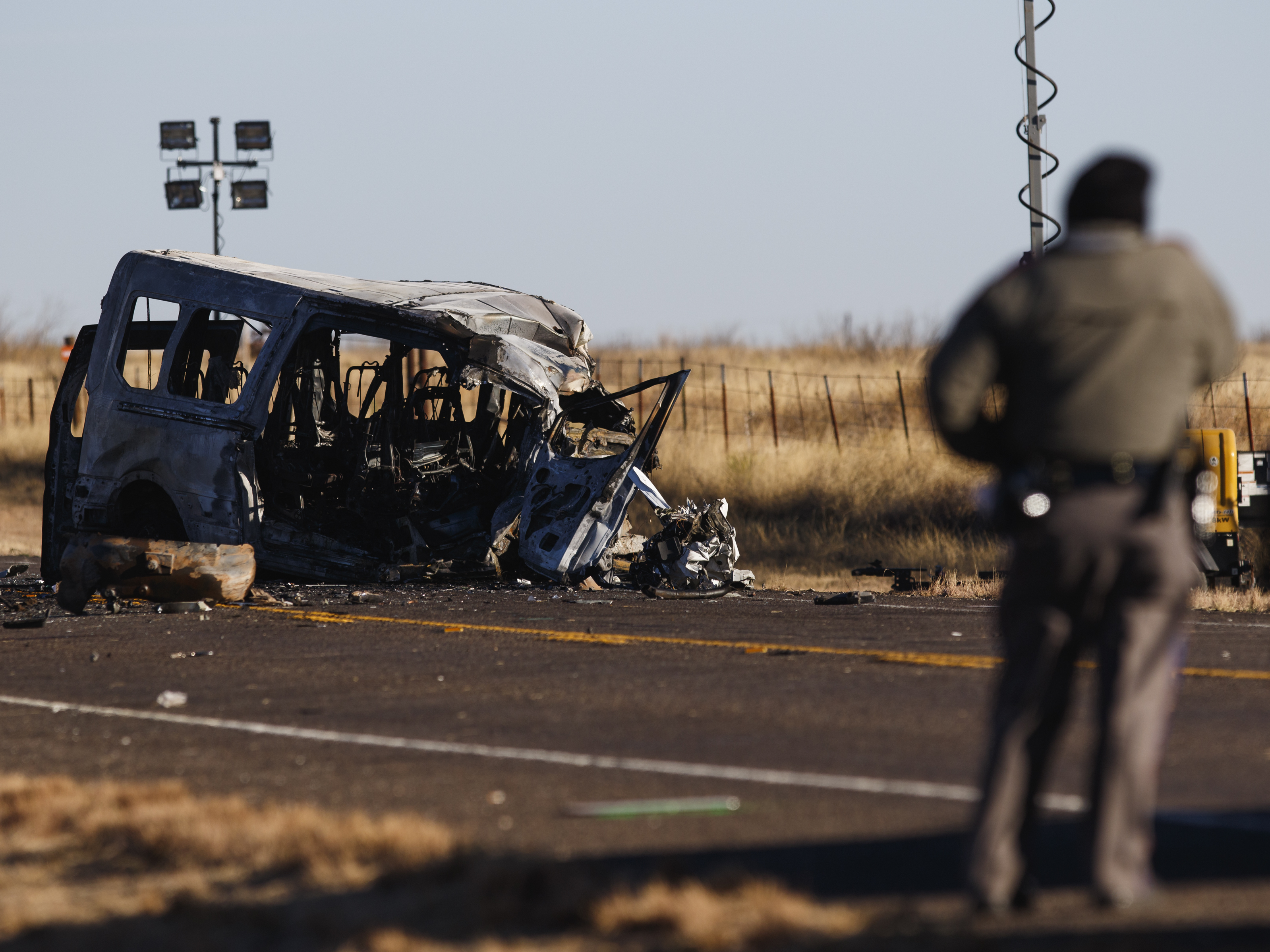 caption: Texas Department of Public Safety troopers look over the scene of a fatal accident early Wednesday, in Andrews County, Texas. Nine people were killed when a pickup truck crossed the center line of a two-lane road Tuesday evening and crashed into a van carrying members of the University of the Southwest men's and women's golf teams.