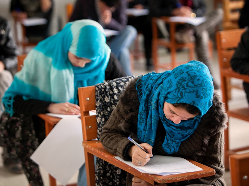 caption: In December, the Taliban banned female students from attending university. Some of them are turning to online options. Above: Afghan female students attend Kabul University in 2010.