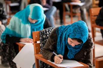 caption: In December, the Taliban banned female students from attending university. Some of them are turning to online options. Above: Afghan female students attend Kabul University in 2010.