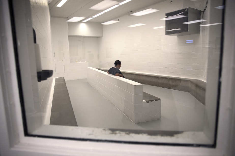 caption: A detainee sits in the intake area at the Northwest Detention Center on Wednesday, June 21, 2017, in Tacoma.