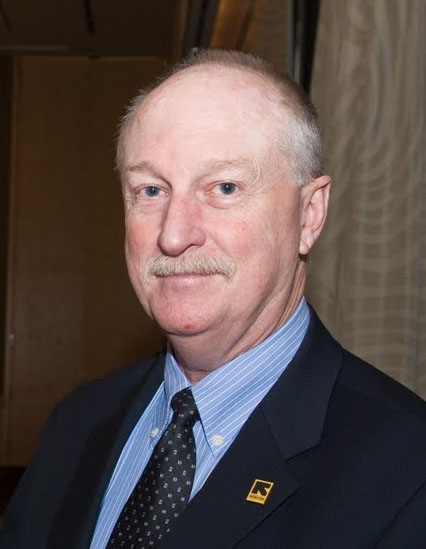 caption: Bob Johnson started at the International Rescue Committee (IRC) in San Francisco, in 1976. He took charge of the Seattle office in 1977, and led the organization for decades, until his retirement in 2016. 