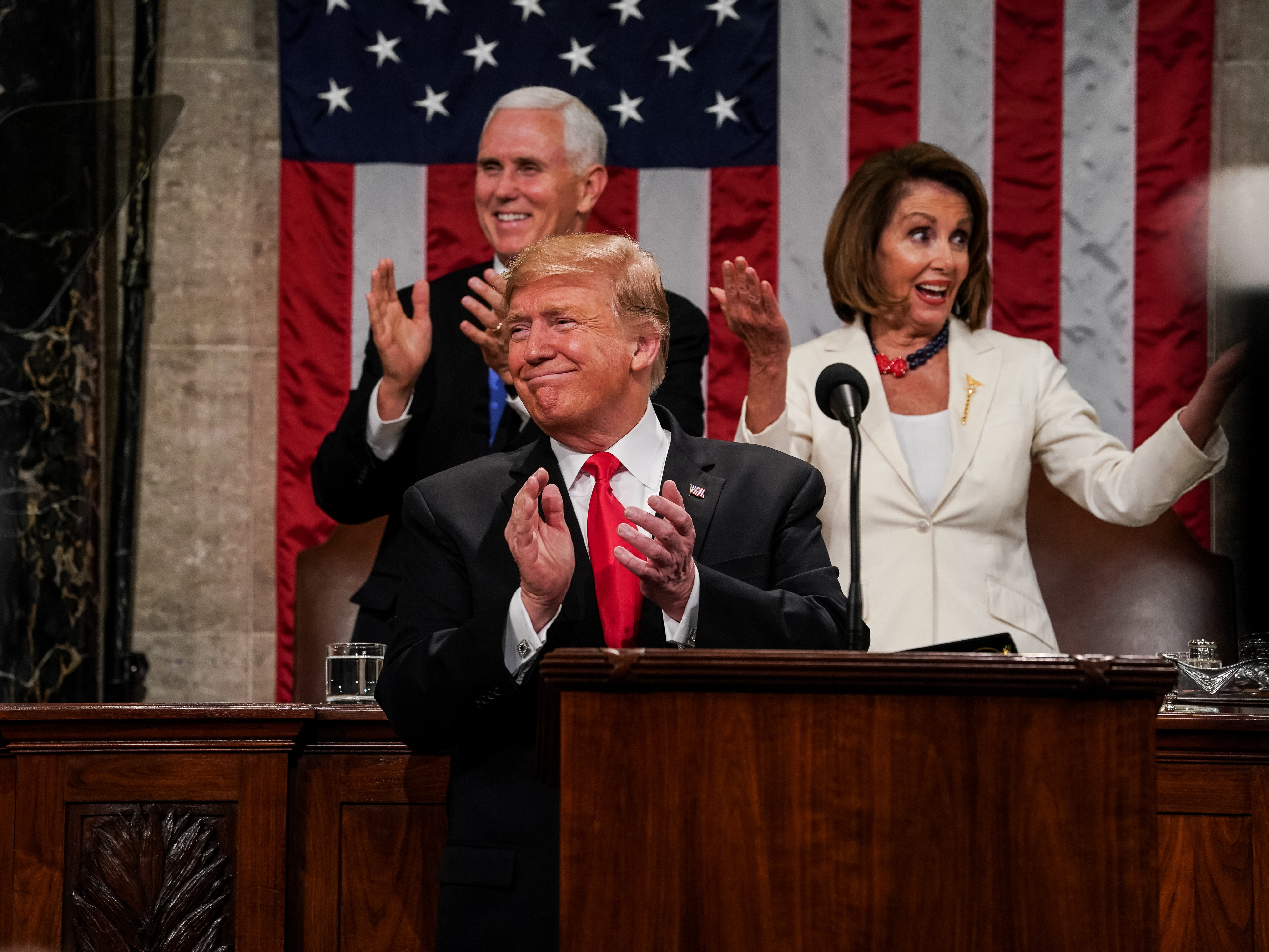 caption: President Donald Trump, Speaker Nancy Pelosi and Vice President Mike Pence applaud during the State of the Union address on February 5, 2019.