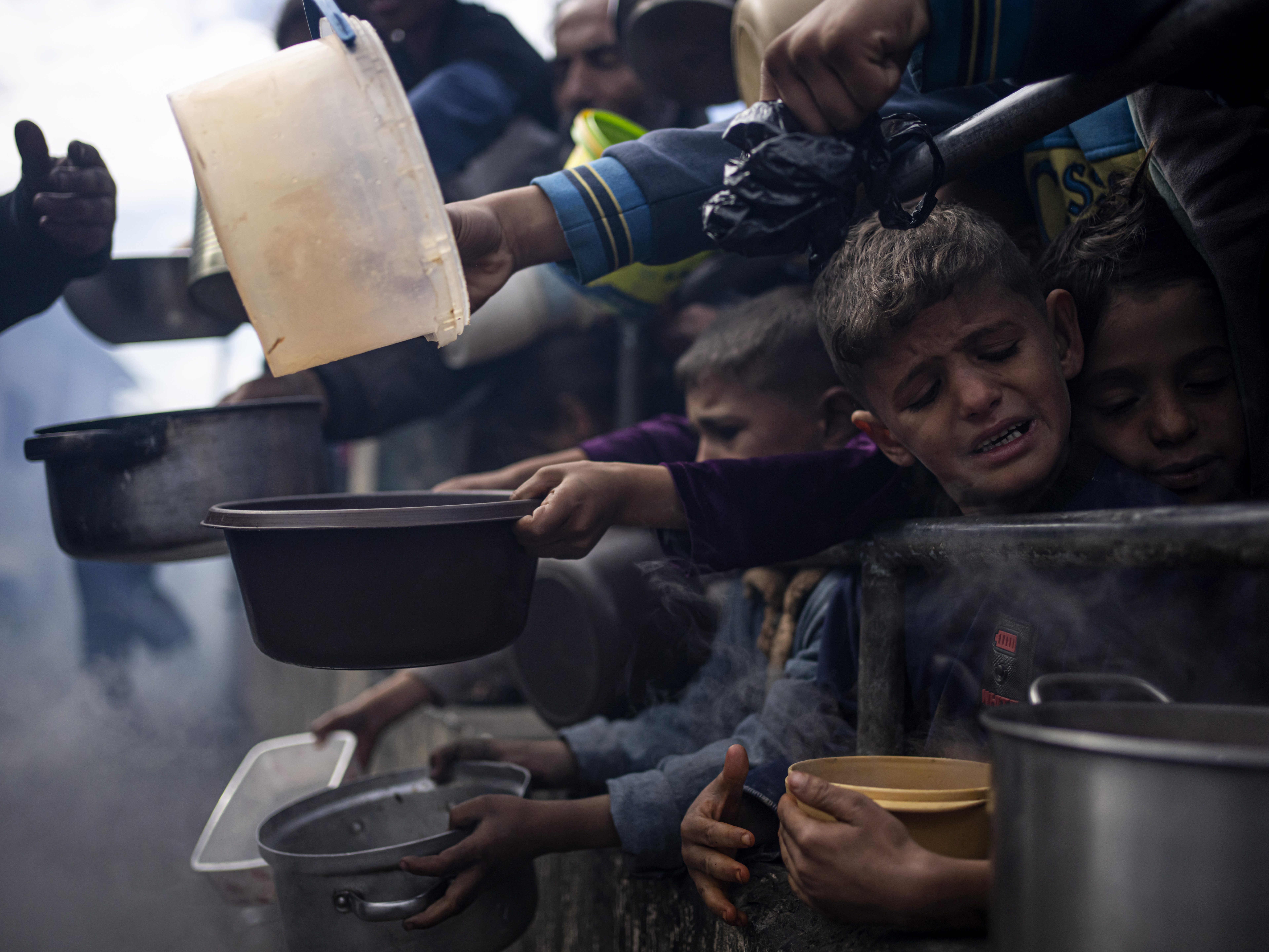 caption: Palestinians line up for a meal in Rafah, Gaza Strip, Feb. 16.