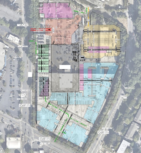 caption: A building and land use preapplication proposes the demolition of the existing Lowes building, making room for a new distribution facility (identified in redacted text as a "delivery station building") surrounded by parking lots and vehicle staging areas. White redacted text at left obscures a reference to Amazon.