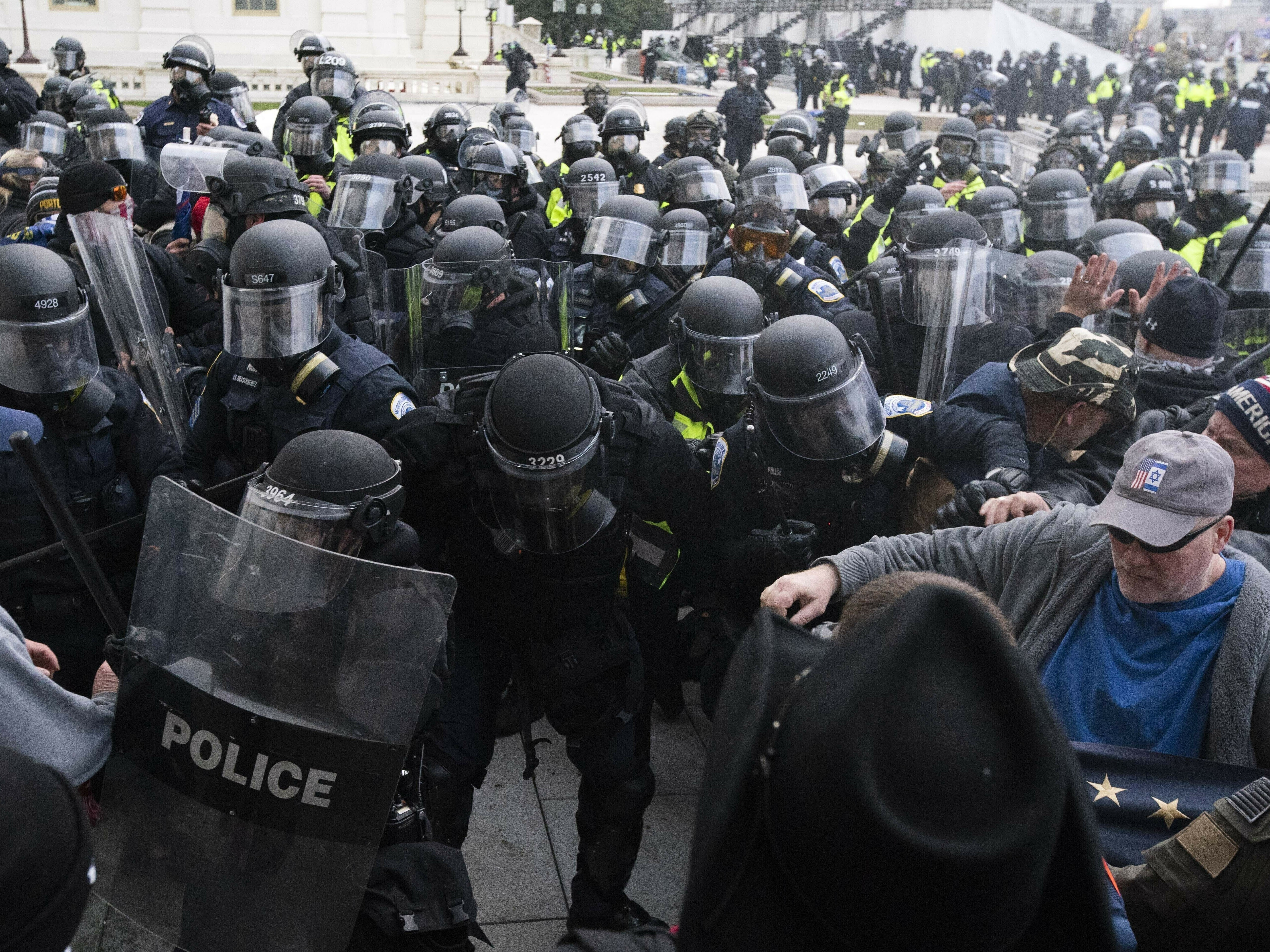 caption: In this Jan. 6, 2021, file photo, U.S. Capitol Police push back rioters trying to enter the U.S. Capitol in Washington.