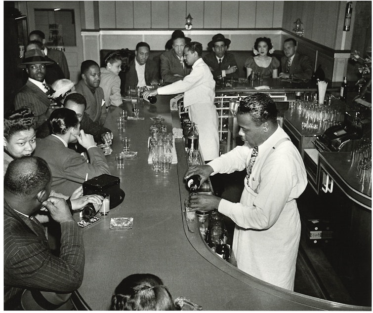 caption: The Rocking Chair, 1946, an after-hours club, known for being where Ray Charles launched his reputation. (To help us ID these bartenders and patrons, note the photo number. This is #13.)