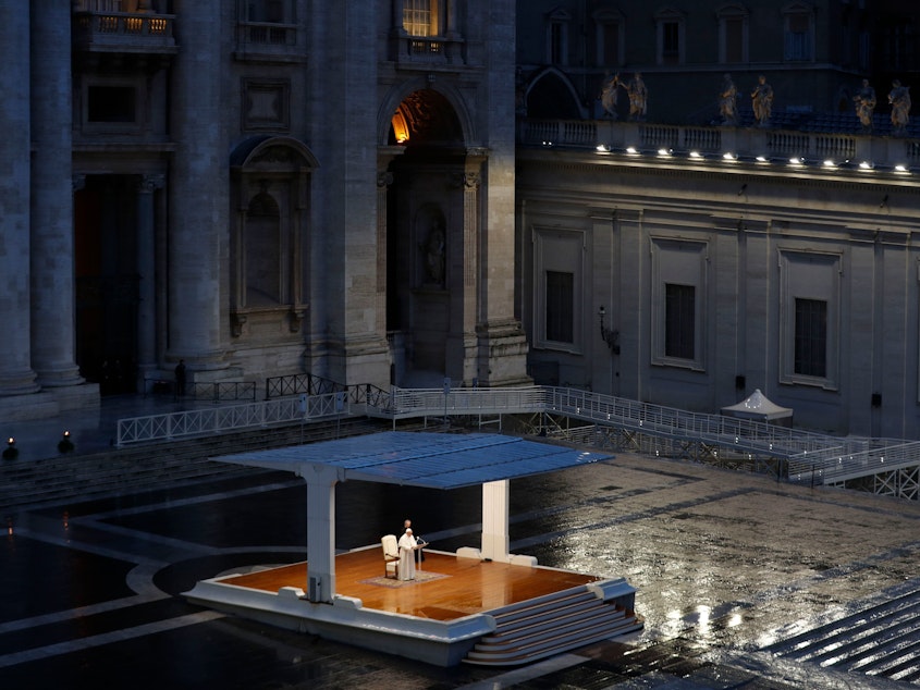 caption: Pope Francis delivers the Urbi and Orbi ("To the City and To the World") prayer in an empty St. Peter's Square Friday evening.