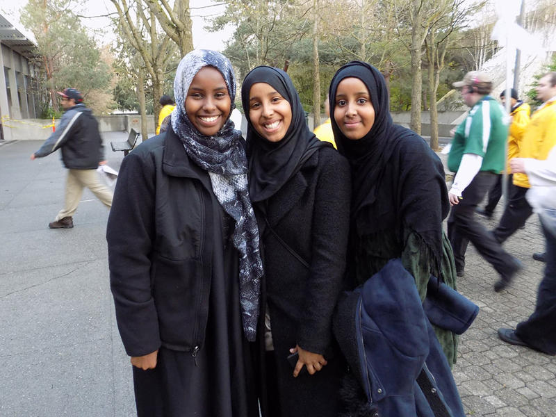caption: Sarah and her friends Aisha and Anisa. Sarah came to support Sanders and "what he stands for."
