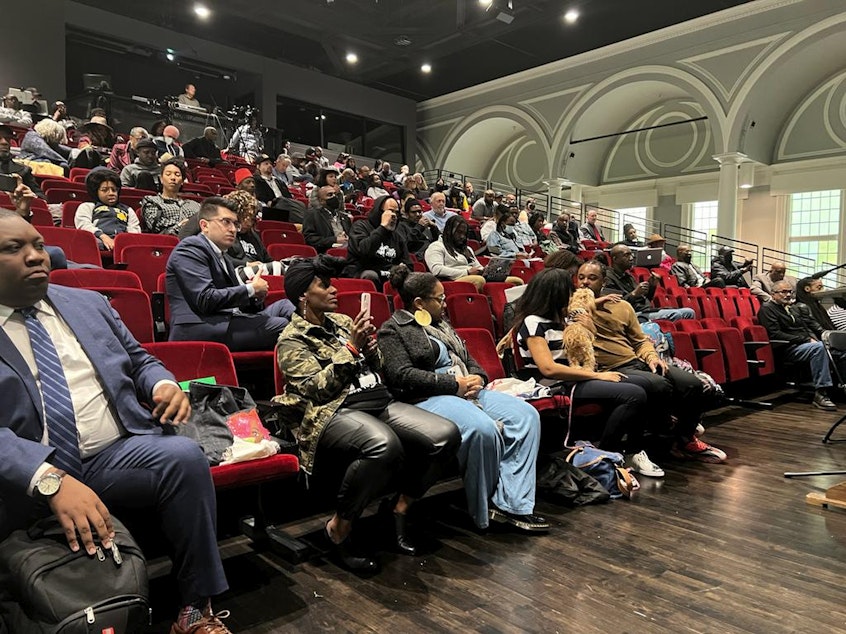 caption: People listen to the California reparations task force, a nine-member committee studying restitution proposals for African Americans, at a meeting at Lesser Hall in Mills College at Northeastern University in Oakland, Calif., on Saturday, May 6, 2023.