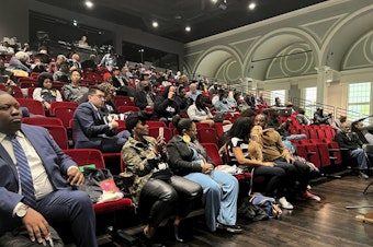 caption: People listen to the California reparations task force, a nine-member committee studying restitution proposals for African Americans, at a meeting at Lesser Hall in Mills College at Northeastern University in Oakland, Calif., on Saturday, May 6, 2023.