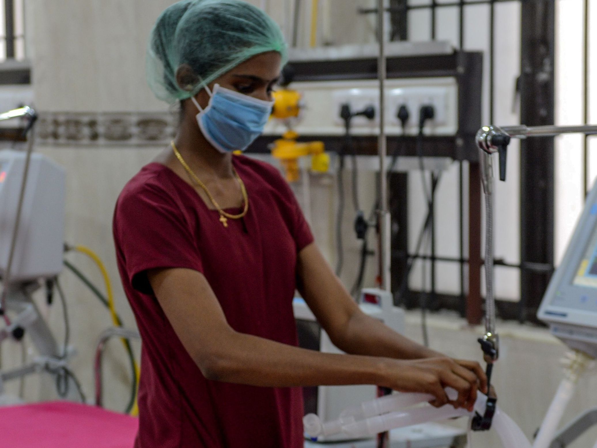 caption: A medical staff member checks on a ventilator in an intensive care unit. President Trump and New York Gov. Andrew Cuomo are locked in a dispute about New York's need for ventilators amid the coronavirus.