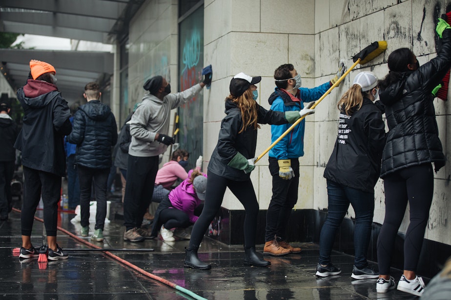 caption: People descended on downtown Seattle on Sunday morning to scrub down the city after a day and night of protests against racism. The protests for were George Floyd, a Black man who died at the hands of police in Minneapolis.
