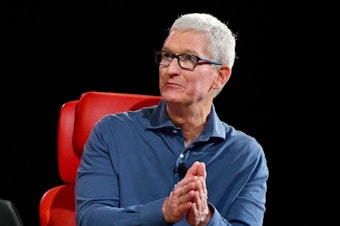 caption: Apple CEO Tim Cook speaks onstage during Vox Media's 2022 Code Conference in Beverly Hills, Calif.