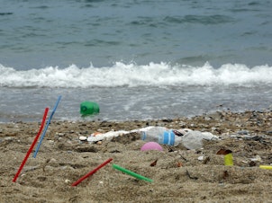 caption: Plastic garbage lying on the Aegean sea beach in Greece.