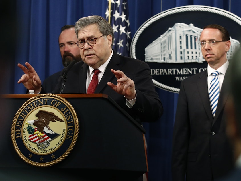 caption: Attorney General William Barr, center, holds a press conference Thursday before the redacted Mueller report's release.
