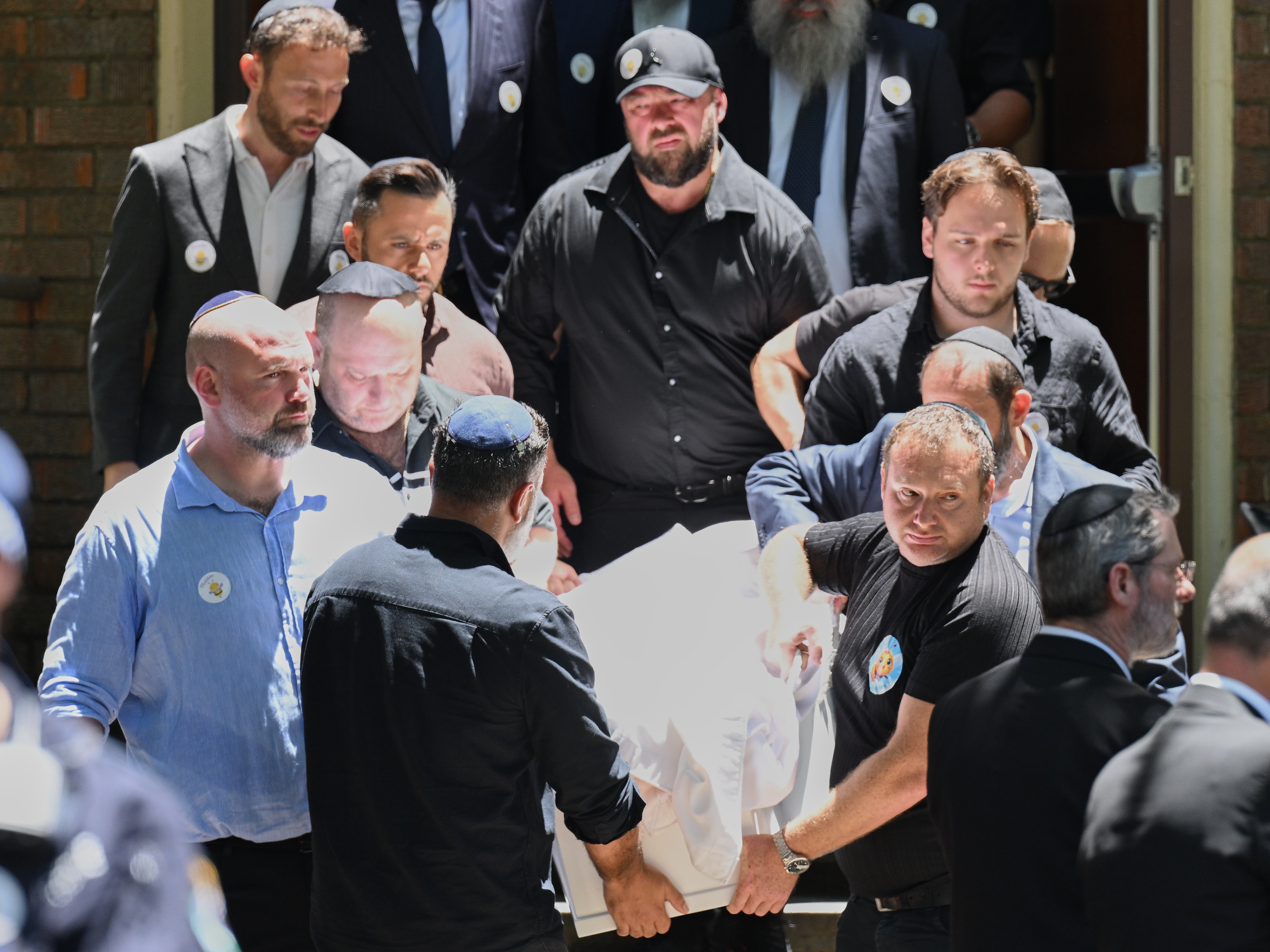 caption: Family carry the coffin following a service for Bondi Beach mass shooting victim 10-year-old Matilda, whose last name is being withheld at the request of her family, in Sydney, Thursday, Dec. 18, 2025.