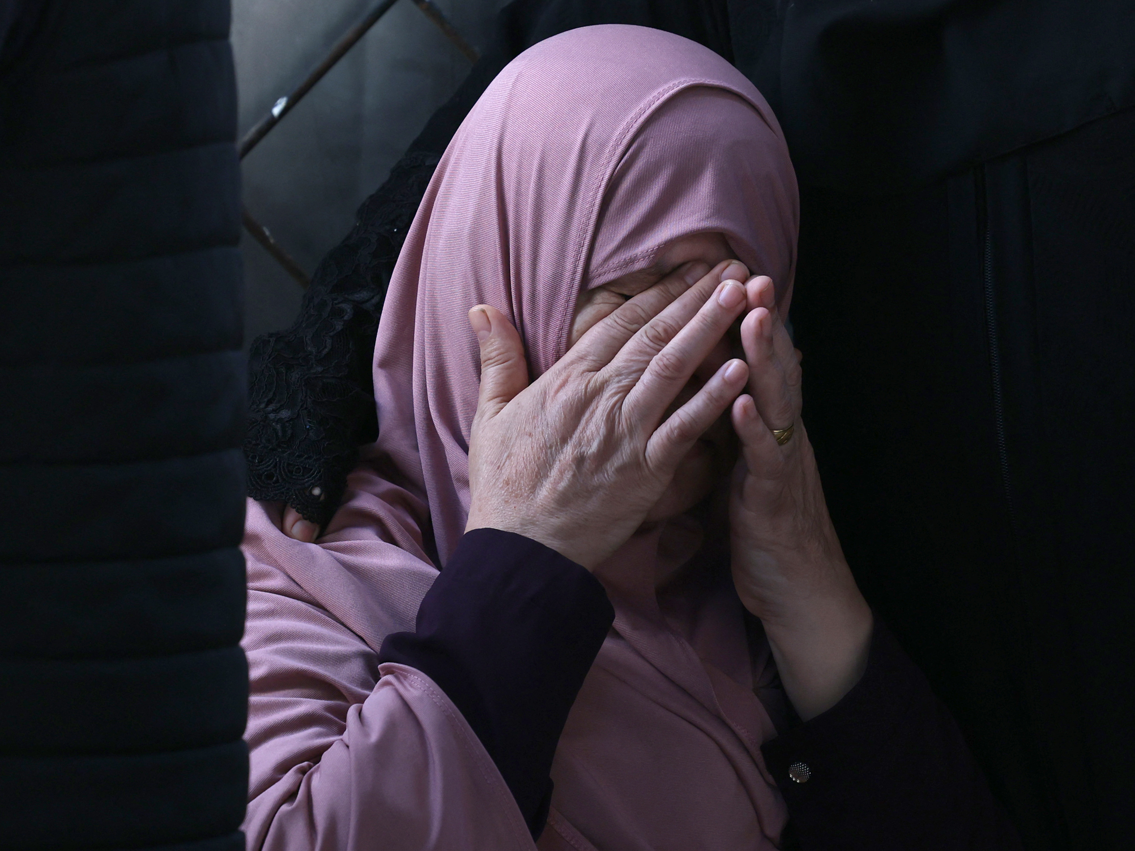caption: A Palestinian woman mourns after an Israeli airstrike at the Rafah refugee camp, in the southern Gaza Strip on Tuesday.